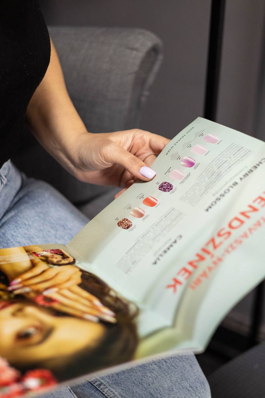 A guest browsing the GoodLakk trend colour catalogue in the salon