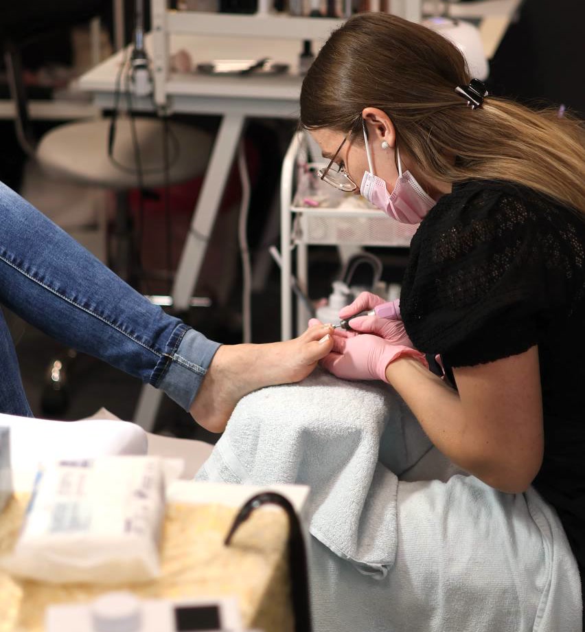 Our colleague performing a machine pedicure on a guest at the GoodLakk salon
